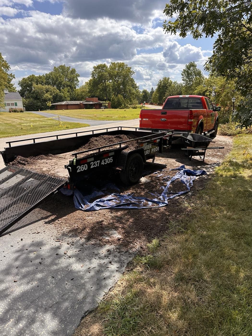 Premier Turf Pros branded truck and trailer loaded with mulch